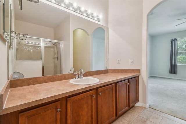 bathroom with vanity, ceiling fan, tile patterned floors, and an enclosed shower