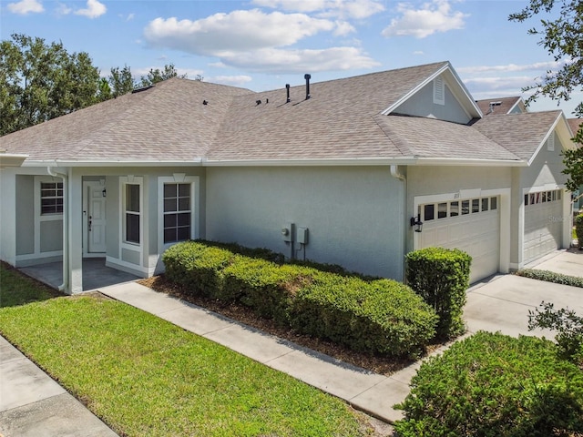 single story home featuring a front yard and a garage