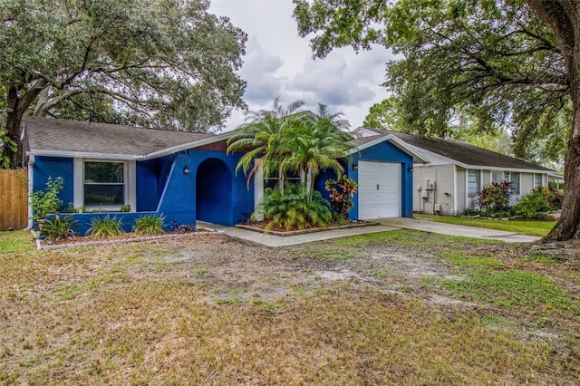 single story home featuring a garage and a front yard