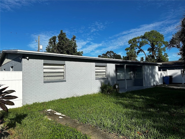 view of side of home featuring a lawn