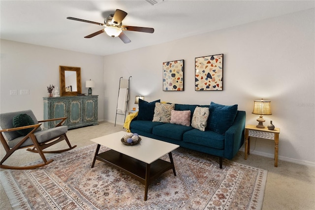 carpeted living room with ceiling fan