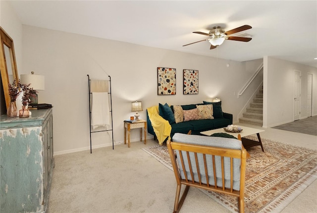 living area with ceiling fan and carpet