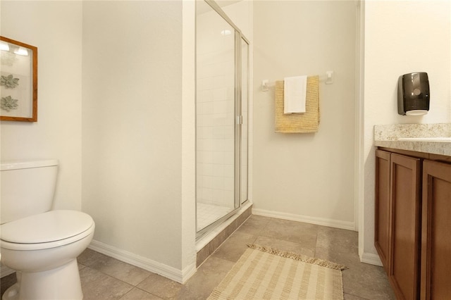 bathroom with vanity, toilet, tile patterned floors, and a shower with door