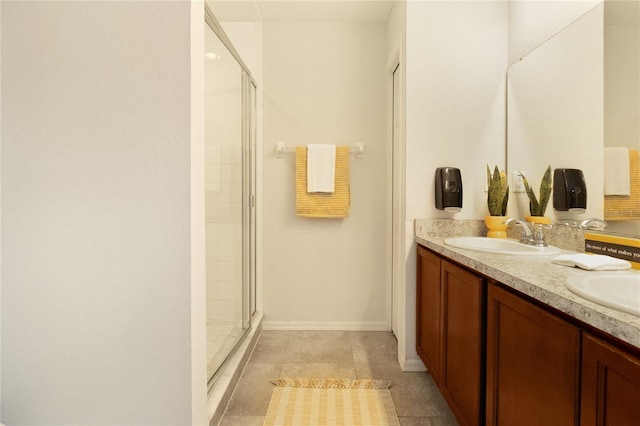 bathroom with tile patterned flooring, a shower with shower door, and vanity