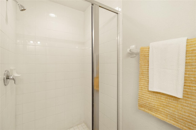 bathroom featuring a shower with door