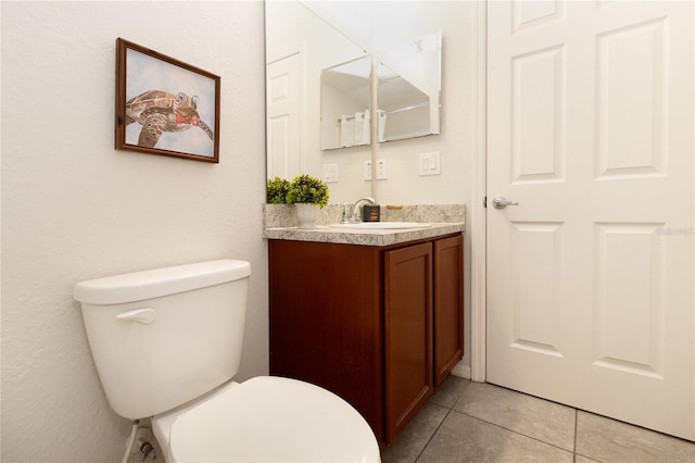 bathroom featuring vanity, toilet, and tile patterned flooring