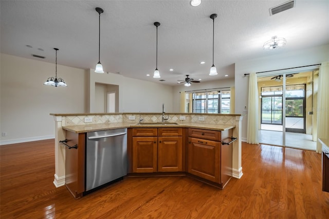 kitchen with backsplash, dark wood-type flooring, stainless steel dishwasher, and sink