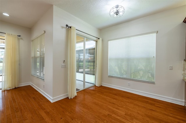 doorway featuring wood-type flooring and a textured ceiling