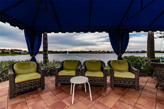 view of patio / terrace featuring a gazebo and a water view