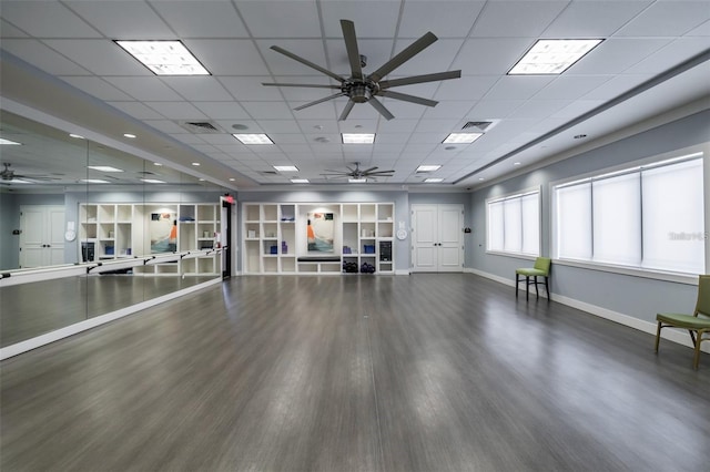 exercise room featuring baseboards, visible vents, a ceiling fan, and wood finished floors