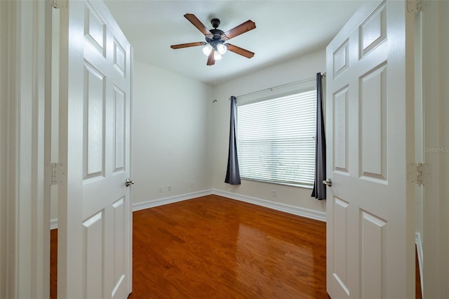 unfurnished bedroom with ceiling fan and hardwood / wood-style flooring