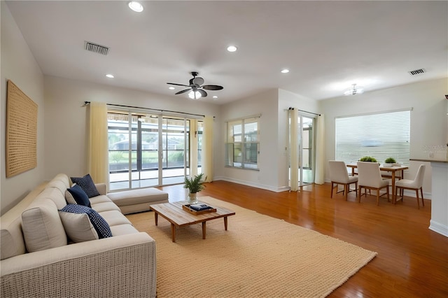 living room with hardwood / wood-style floors and ceiling fan