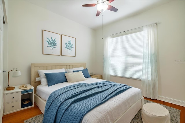 bedroom with ceiling fan and light hardwood / wood-style flooring