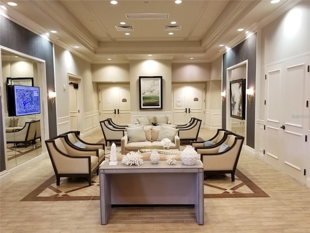 interior space with a raised ceiling, crown molding, and light hardwood / wood-style flooring