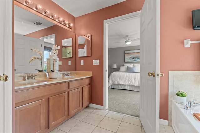 bathroom featuring vanity, tile patterned flooring, ceiling fan, and a bathtub