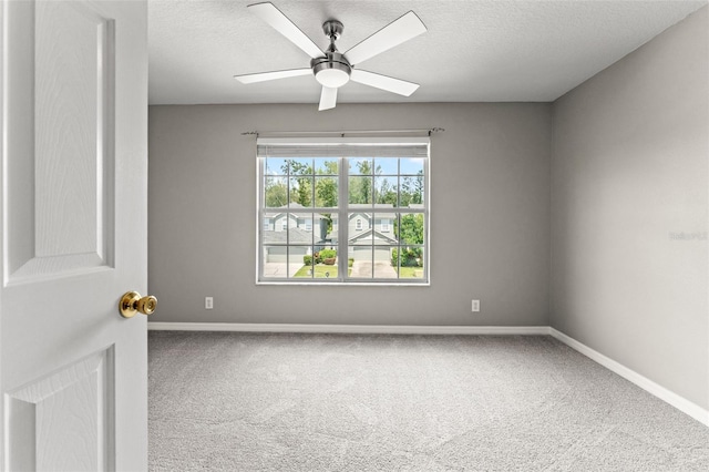 carpeted empty room featuring a textured ceiling and ceiling fan