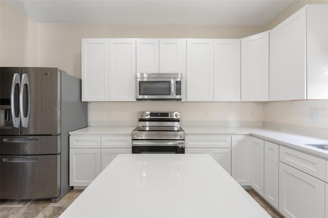 kitchen featuring white cabinetry and appliances with stainless steel finishes