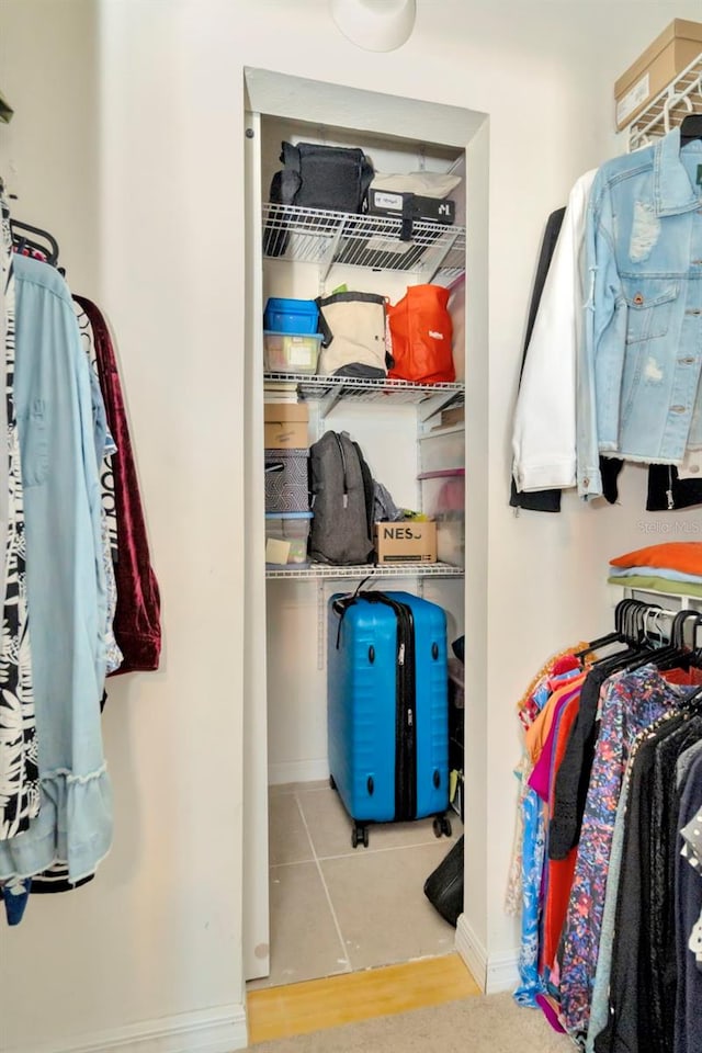 spacious closet featuring light tile patterned flooring