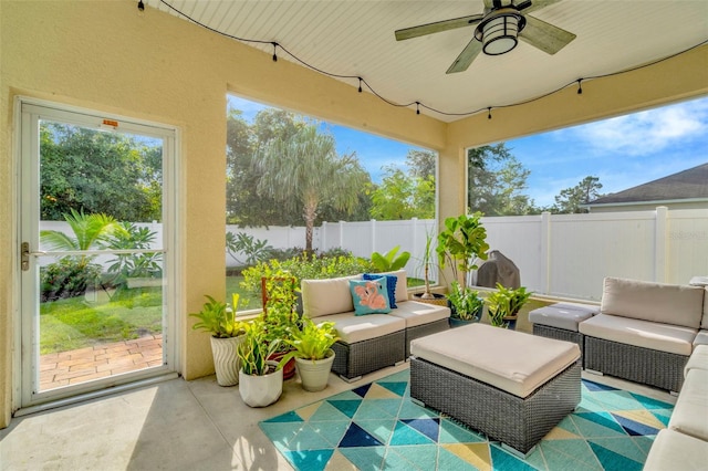 sunroom featuring a wealth of natural light and ceiling fan