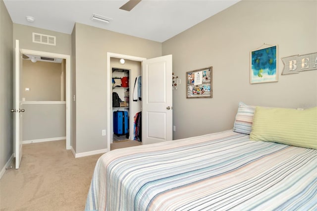 carpeted bedroom with ceiling fan and a closet