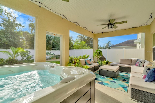 view of patio / terrace featuring outdoor lounge area, ceiling fan, and a hot tub