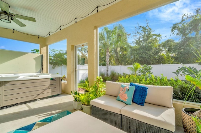 view of patio / terrace featuring outdoor lounge area, ceiling fan, and a hot tub