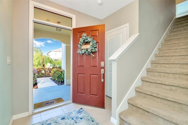 foyer entrance with light tile patterned floors