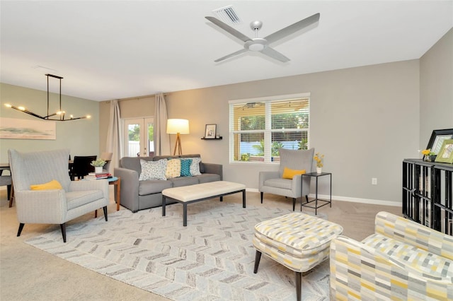 living room with light carpet, french doors, and a healthy amount of sunlight