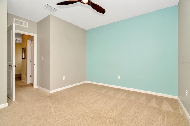 empty room with ceiling fan and light colored carpet