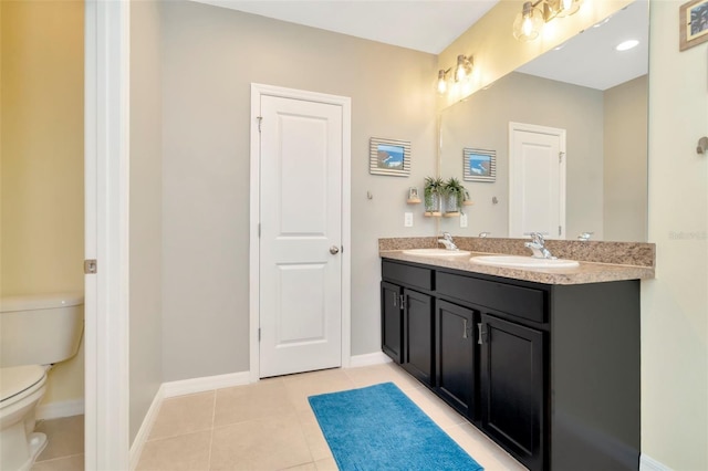 bathroom with tile patterned floors, vanity, and toilet