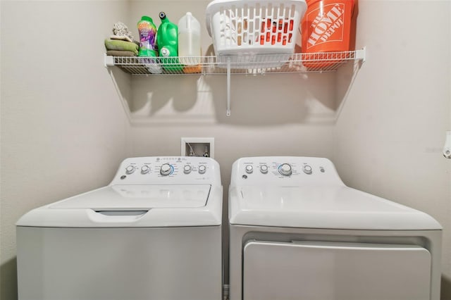clothes washing area featuring washing machine and clothes dryer and laundry area