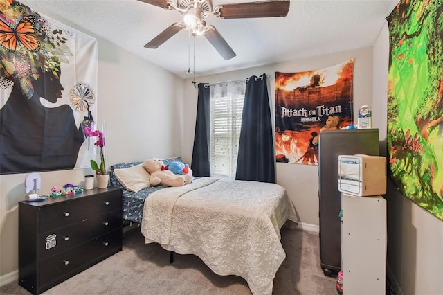 bedroom featuring a textured ceiling, ceiling fan, and carpet floors