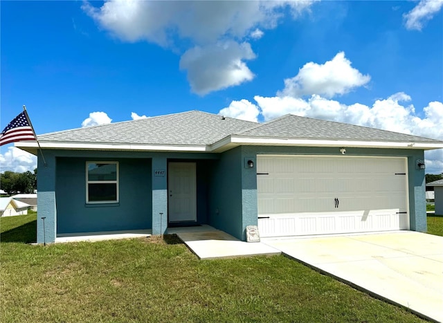 ranch-style home featuring a garage and a front lawn