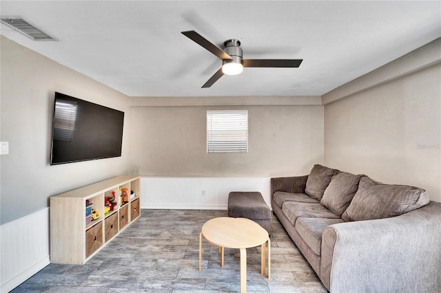 living room featuring hardwood / wood-style floors and ceiling fan