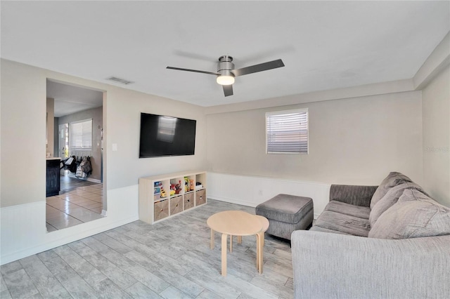 living room featuring ceiling fan and hardwood / wood-style floors