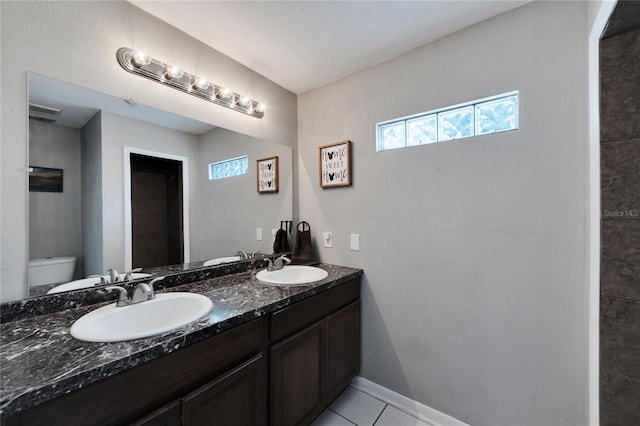 bathroom featuring tile patterned floors, vanity, and toilet