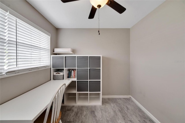 office with hardwood / wood-style floors and ceiling fan