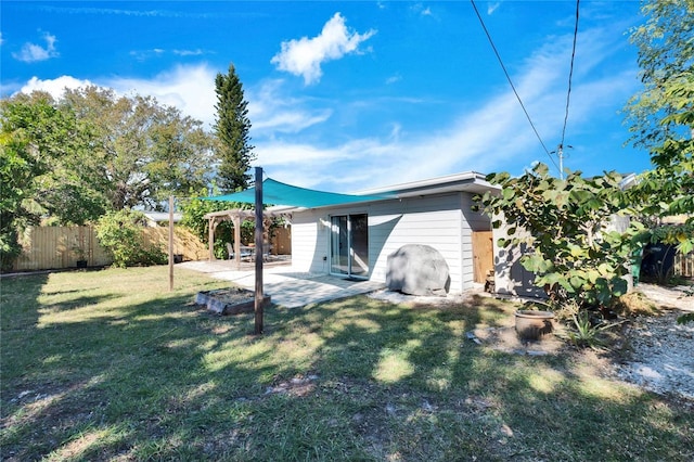 back of property featuring a patio area and a lawn