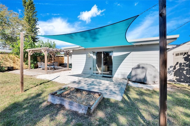 rear view of property featuring a pergola, a yard, and a patio