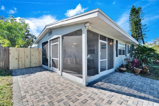 view of home's exterior featuring a patio area and a sunroom