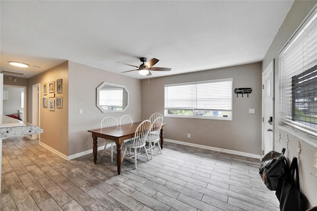 dining space with ceiling fan and light hardwood / wood-style floors