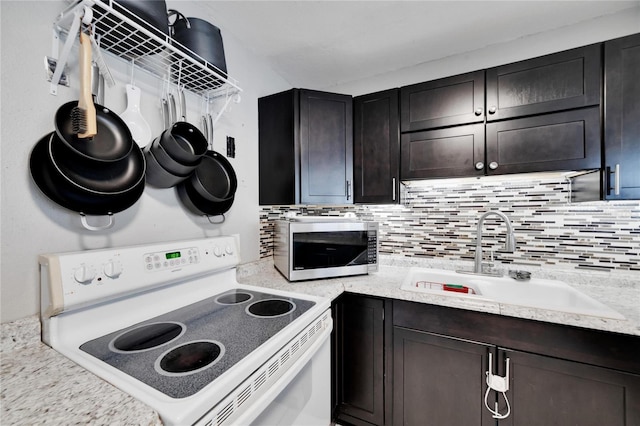 kitchen with decorative backsplash, dark brown cabinets, electric stove, and sink