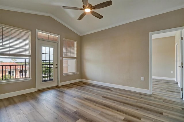 spare room featuring vaulted ceiling, light hardwood / wood-style flooring, ceiling fan, and ornamental molding