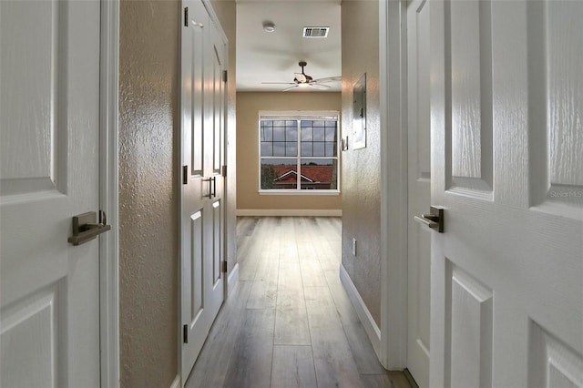 hallway with wood-type flooring