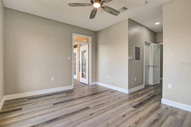 empty room with light hardwood / wood-style flooring and ceiling fan