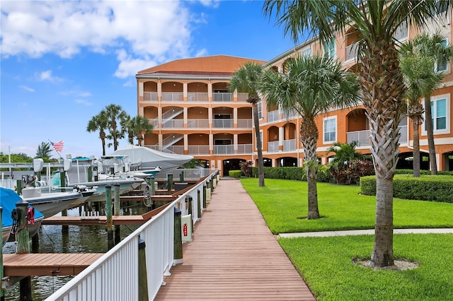 dock area featuring a lawn and a water view