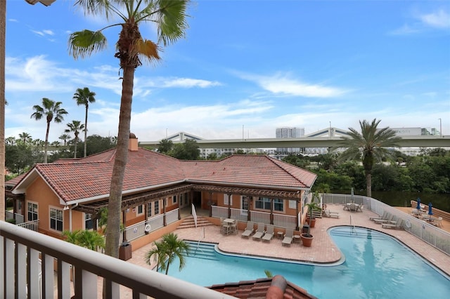 rear view of house featuring a patio and a community pool