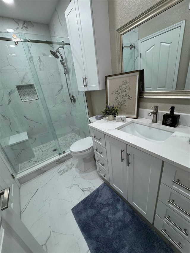 full bathroom featuring marble finish floor, vanity, a marble finish shower, and toilet