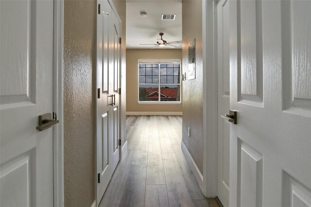 5000 Culbreath Key Way Unit 4-306, Tampa, FL 33611 - hallway featuring baseboards, a textured wall, visible vents, and wood finished floors