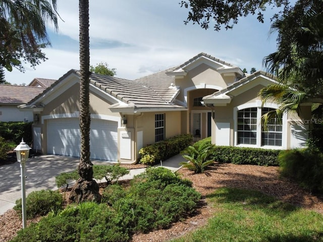 6515 Virginia Xing, University Park, FL 34201 - view of front of property with stucco siding, a tiled roof, concrete driveway, and an attached garage